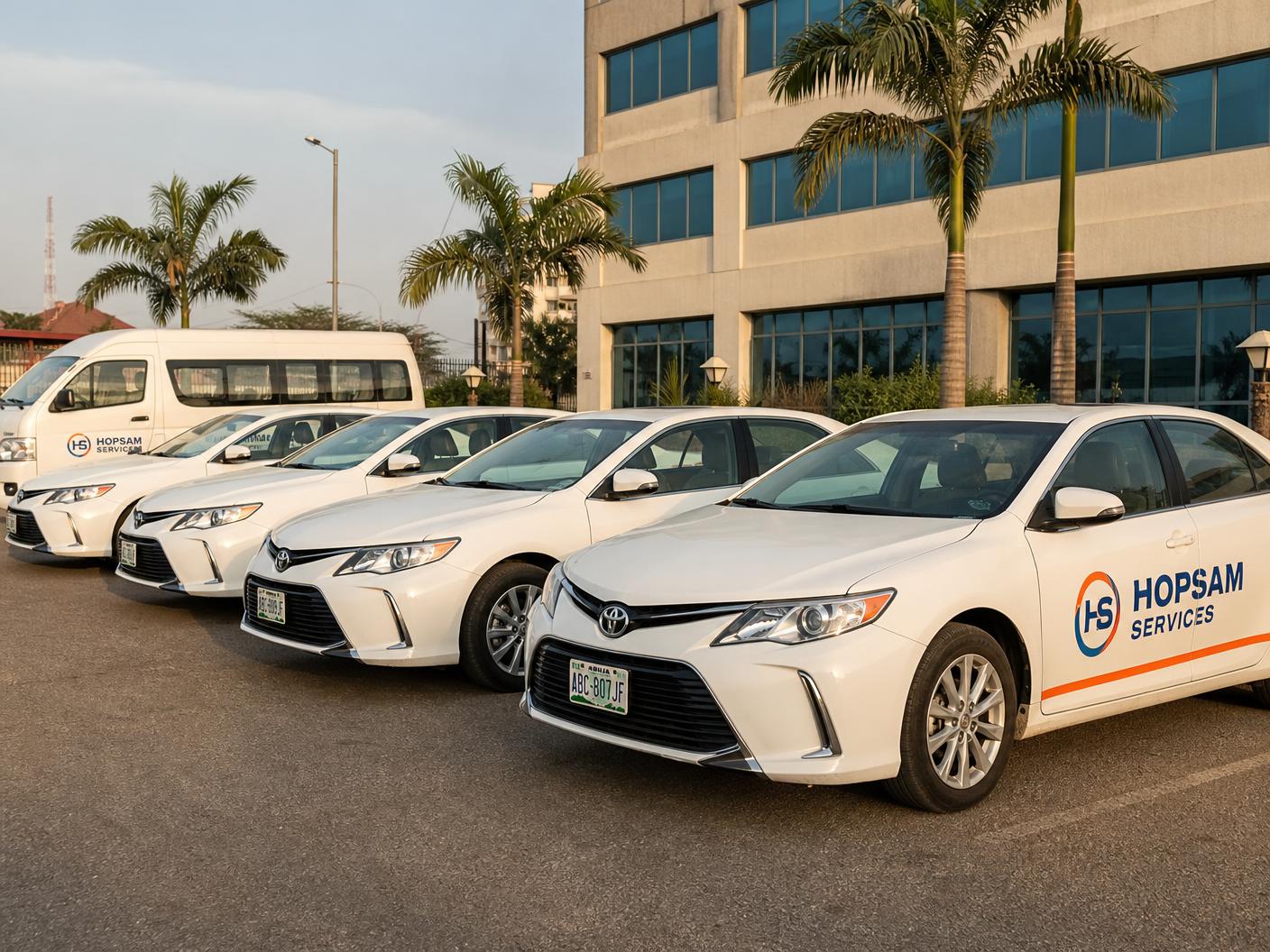 Hopsam Services branded Toyota Camry saloons and passenger van with HS logo livery at an Abuja depot