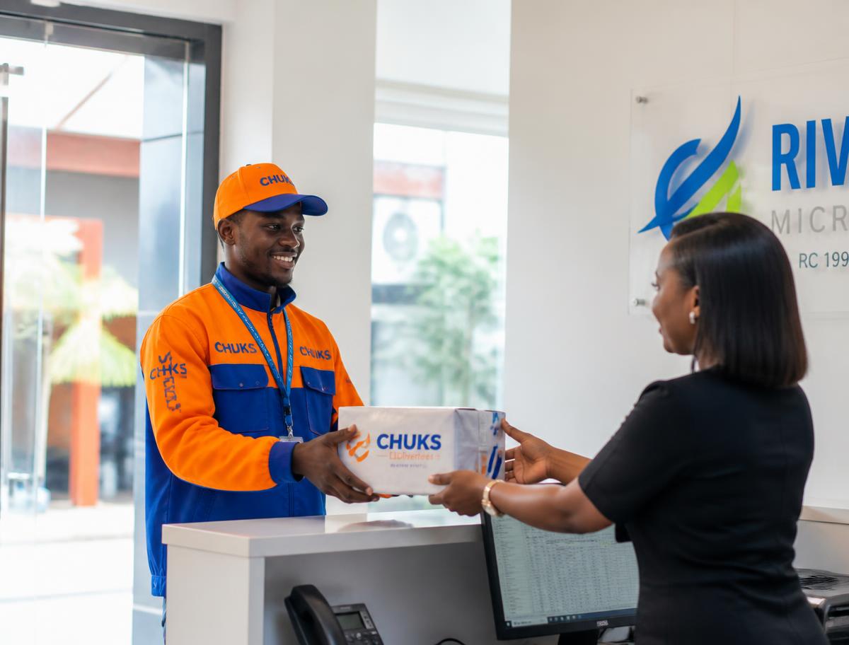 Hopsam Services courier handing a parcel to a customer